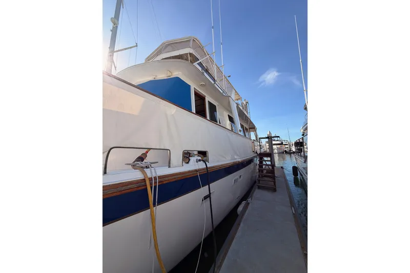 Slide: The Image of 1984 Hartman-Palmer 60 Flush Deck Motor Yacht docked at marina. - 4