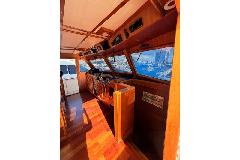 Slide: The Image of 1984 Hartman-Palmer 60 Flush Deck Motor Yacht interior with wooden helm and panoramic windows. - 40