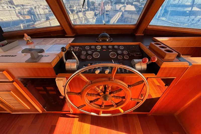Slide: The Image of 1984 Hartman-Palmer 60 Flush Deck Motor Yacht helm with wooden wheel and control panel. - 41