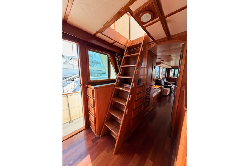 Slide: The Image of 1984 Hartman-Palmer 60 Flush Deck Motor Yacht interior with wooden ladder and cozy seating area. - 53