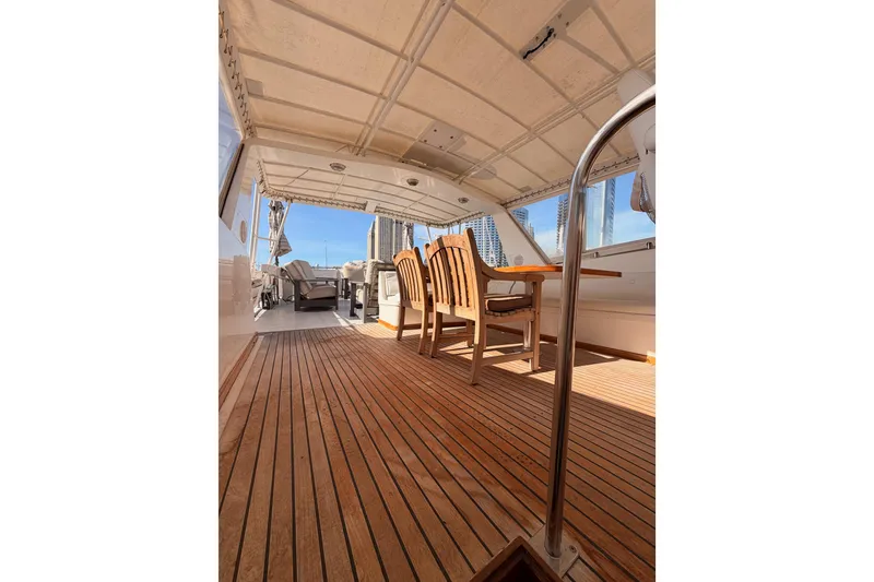 Slide: The Image of 1984 Hartman-Palmer 60 Flush Deck Motor Yacht interior with wooden deck and seating area. - 54