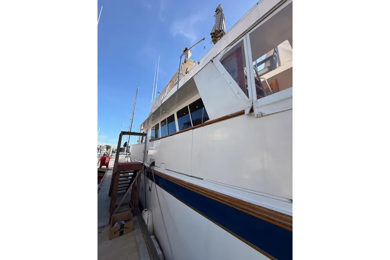 Slide: The Image of 1984 Hartman-Palmer 60 Flush Deck Motor Yacht docked under clear blue sky. - 6