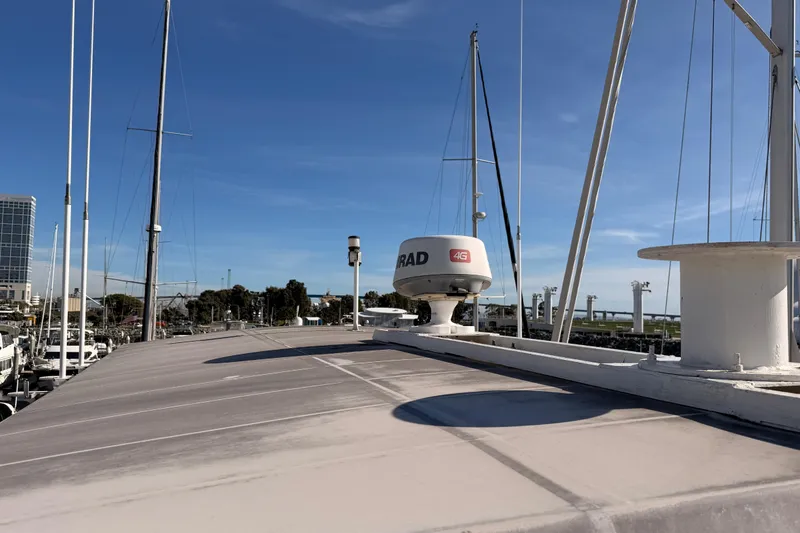 Slide: The Image of 1984 Hartman-Palmer 60 Flush Deck Motor Yacht with radar, docked under clear blue sky. - 61