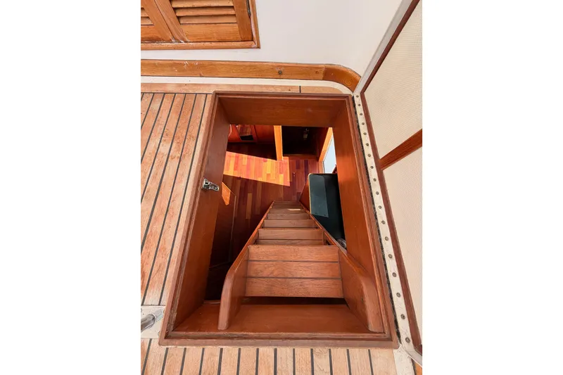 Slide: The Image of Wooden staircase on 1984 Hartman-Palmer 60 Flush Deck Motor Yacht interior. - 68