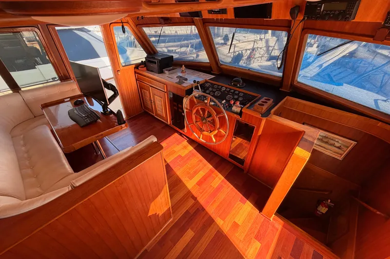 Slide: The Image of Interior of 1984 Hartman-Palmer 60 Flush Deck Motor Yacht with wooden helm and seating area. - 69