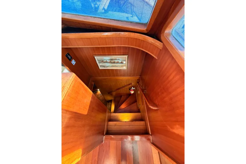 Slide: The Image of Wooden staircase inside 1984 Hartman-Palmer 60 Flush Deck Motor Yacht, featuring nautical decor. - 70