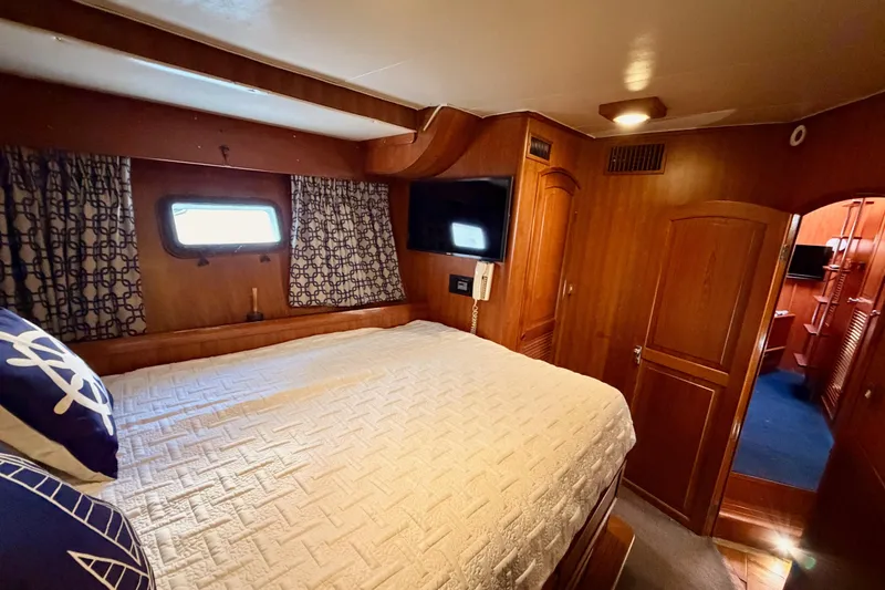 Slide: The Image of Cozy bedroom in 1984 Hartman-Palmer 60 Flush Deck Motor Yacht with wood paneling. - 77