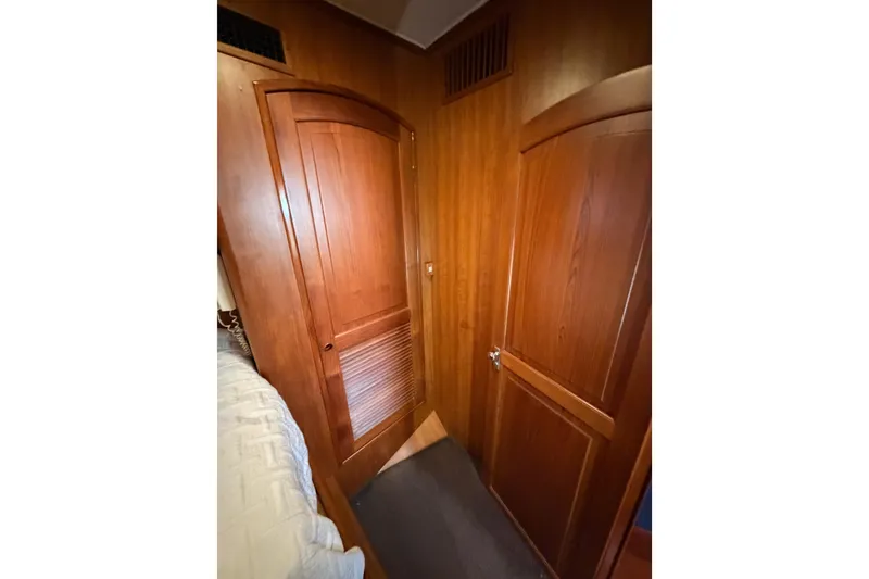 Slide: The Image of Wood-paneled interior of 1984 Hartman-Palmer 60 Flush Deck Motor Yacht, featuring two closed doors. - 78