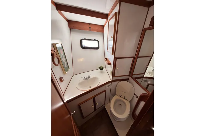 Slide: The Image of 1984 Hartman-Palmer yacht bathroom with sink, toilet, and wooden accents. - 80
