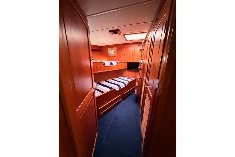 Slide: The Image of 1984 Hartman-Palmer 60 Flush Deck Motor Yacht cabin with wooden interior and bunk beds. - 81