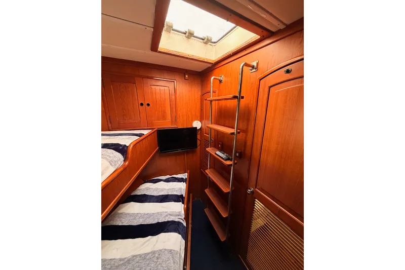 Slide: The Image of Interior of 1984 Hartman-Palmer 60 Flush Deck Motor Yacht with wooden bunk beds and ladder. - 83