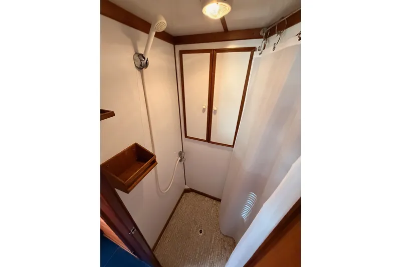 Slide: The Image of 1984 Hartman-Palmer yacht shower with wooden accents and white fixtures. - 85