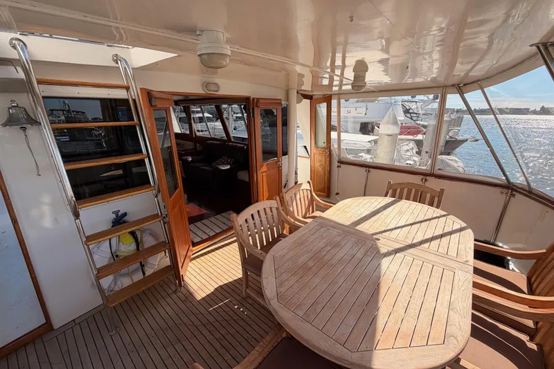 Slide: The Image of 1984 Hartman-Palmer 60 Flush Deck Motor Yacht with wooden deck and seating area. - 9