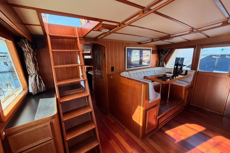 Slide: The Image of Interior of 1984 Hartman-Palmer 60 Flush Deck Motor Yacht with wood paneling and seating area. - 90