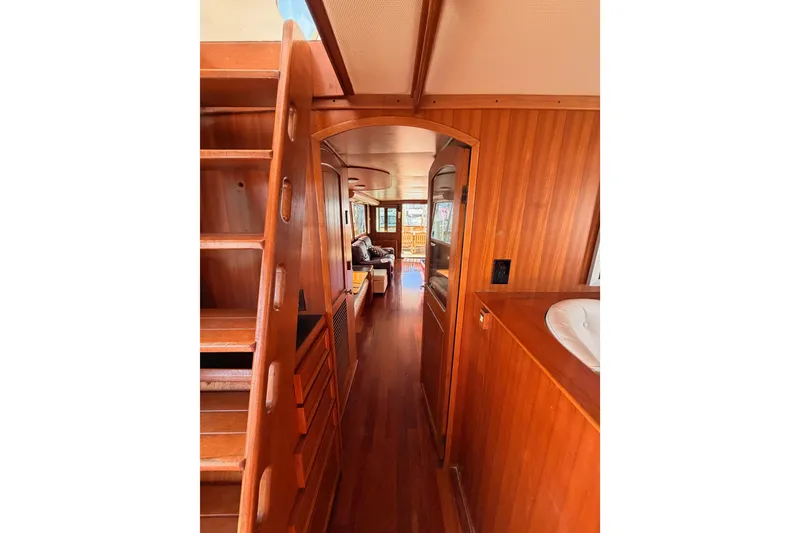 Slide: The Image of Interior of 1984 Hartman-Palmer 60 Flush Deck Motor Yacht with wooden finishes and cozy seating. - 91