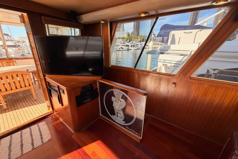 Slide: The Image of Interior of 1984 Hartman-Palmer 60 Flush Deck Motor Yacht with TV and marina view. - 93