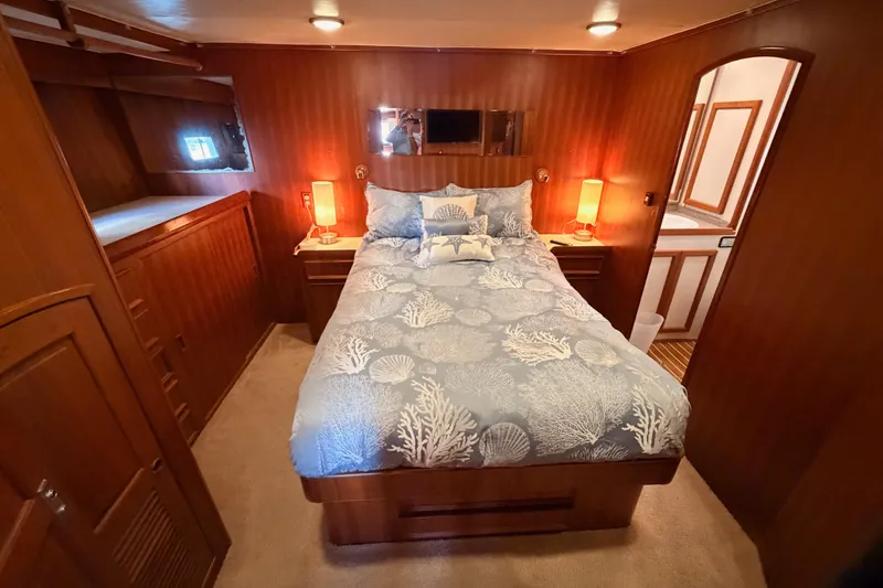 Slide: The Image of Luxurious bedroom in 1984 Hartman-Palmer 60 Flush Deck Motor Yacht, featuring elegant wood paneling. - 98