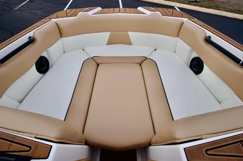 Slide: The Image of 2024 Moomba Max boat interior with tan and white seating, featuring built-in speakers. - 7