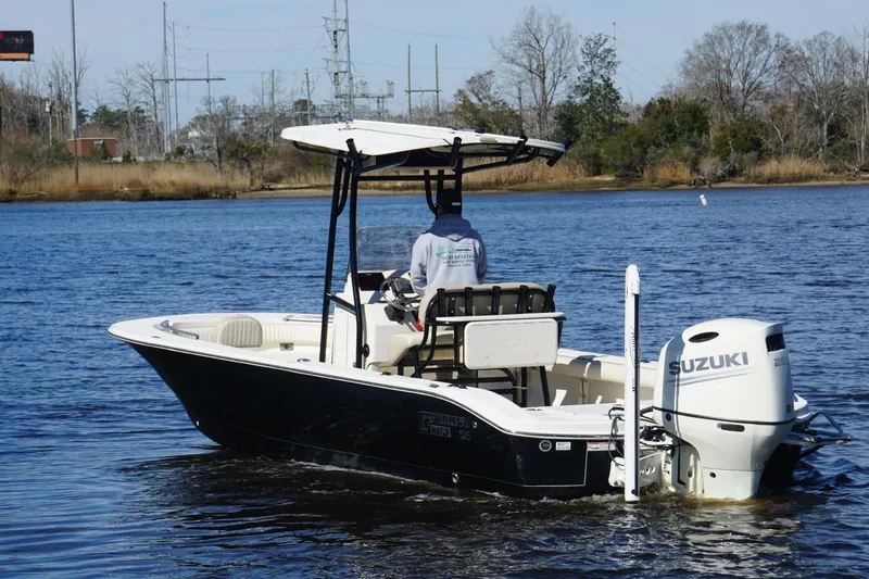Slide: The Image of 2018 Carolina Skiff 24 Ultra Elite boat on water with Suzuki outboard motor. - 12
