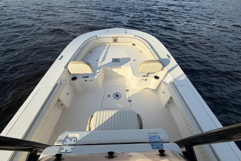 Slide: The Image of 2018 Carolina Skiff 24 Ultra Elite boat interior with seating, on open water. - 5