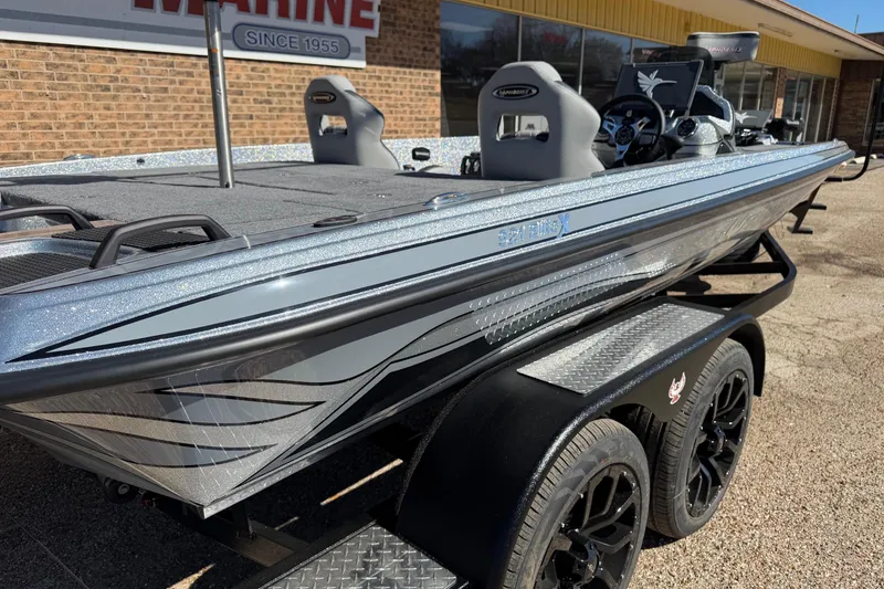 Slide: The Image of Phoenix 921 Elite X 2026 on trailer in front of building. - 10