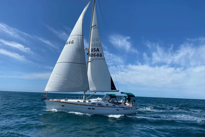Slide: The Image of 2005 Beneteau Oceanis Clipper 423 sailing on open sea under clear blue sky. - 1