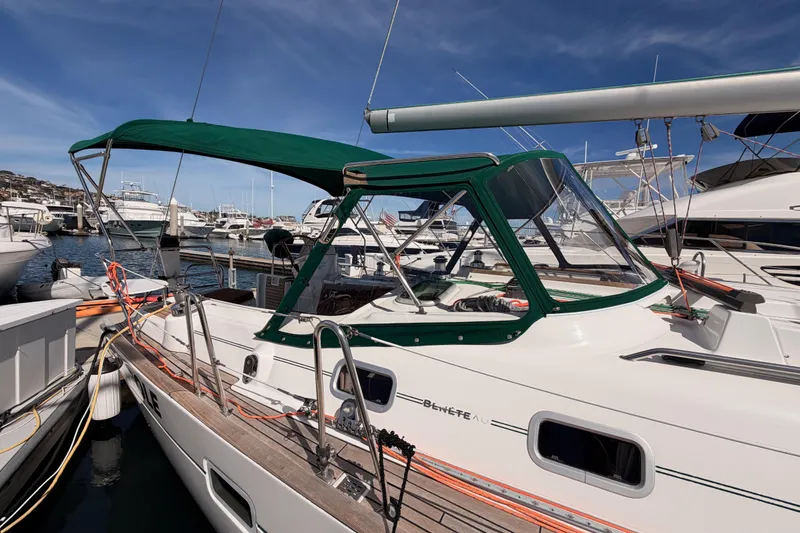 Slide: The Image of 2005 Beneteau Oceanis Clipper 423 sailboat docked at marina, featuring green canopy. - 10