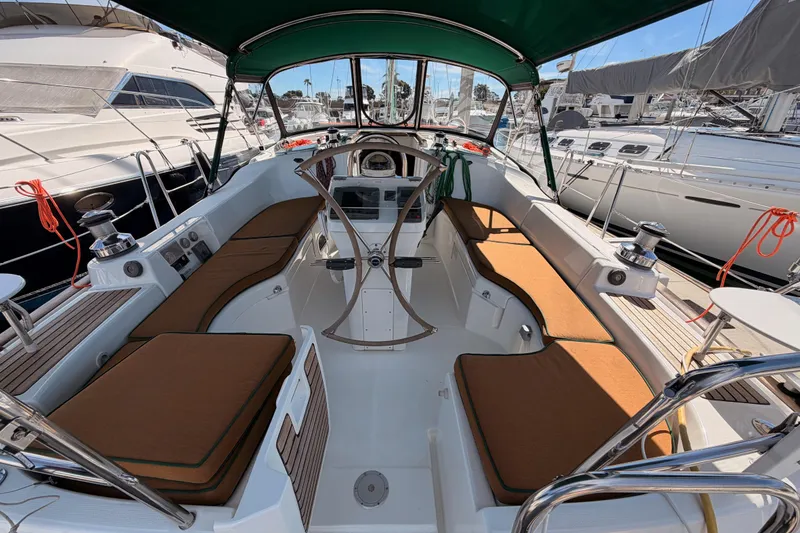 Slide: The Image of 2005 Beneteau Oceanis Clipper 423 yacht cockpit with cushioned seating and steering wheel. - 13