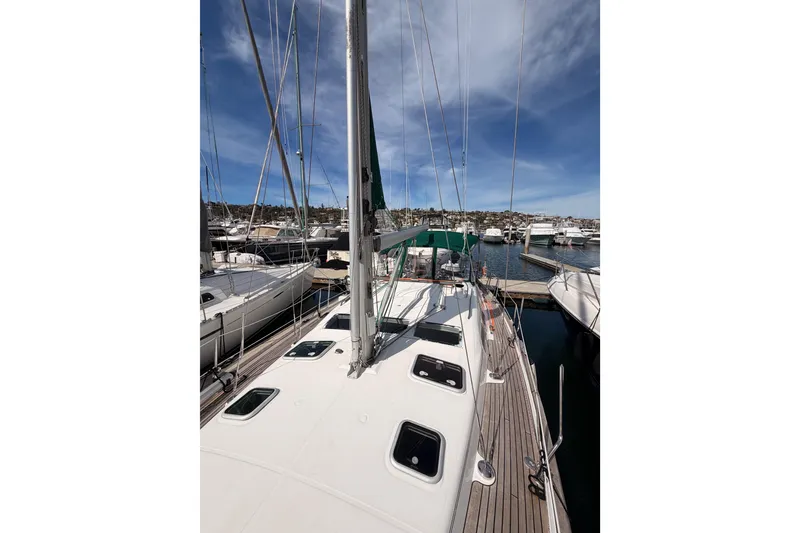 Slide: The Image of 2005 Beneteau Oceanis Clipper 423 sailboat docked at marina under blue sky. - 26