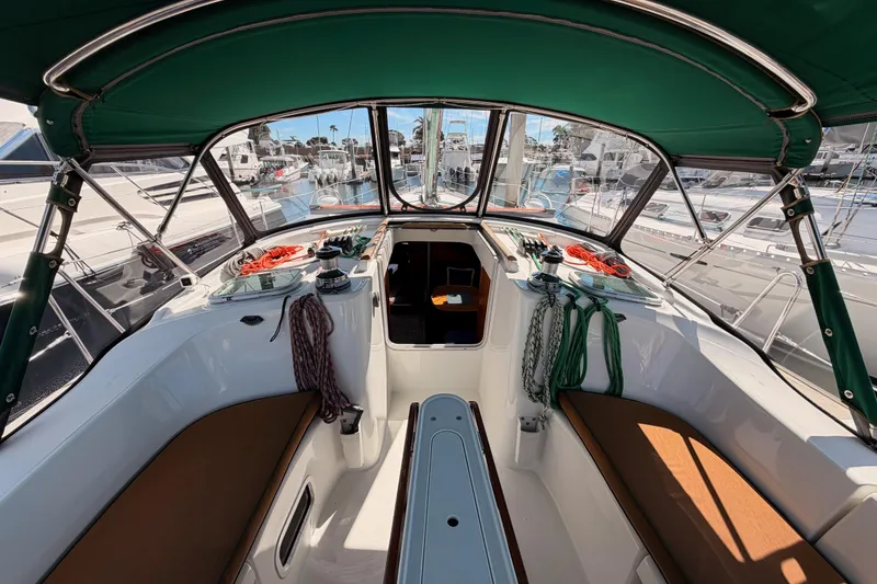 Slide: The Image of Cockpit of 2005 Beneteau Oceanis Clipper 423 sailboat with green canopy and mooring ropes. - 34