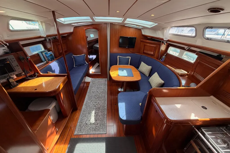 Slide: The Image of Interior of 2005 Beneteau Oceanis Clipper 423 yacht with elegant wood finish and blue seating. - 37