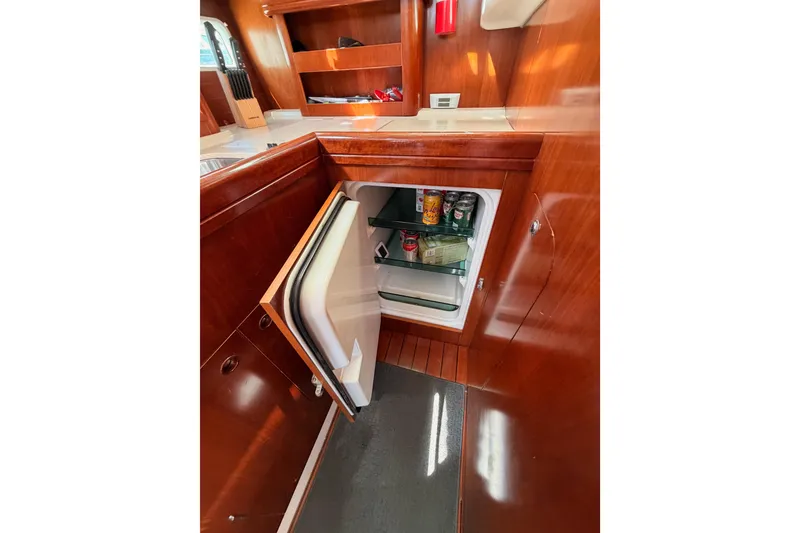 Slide: The Image of Interior of 2005 Beneteau Oceanis Clipper 423 yacht with open fridge in wooden cabinetry. - 41