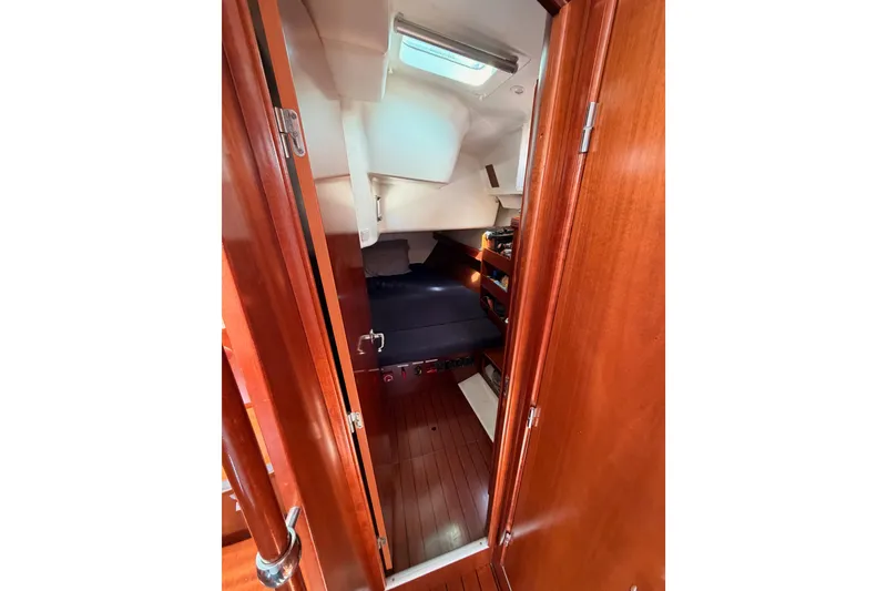 Slide: The Image of Interior cabin of 2005 Beneteau Oceanis Clipper 423 sailboat, featuring wooden finishes and cozy seating. - 47