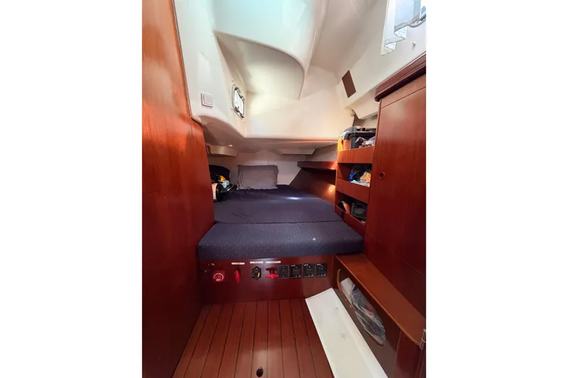 Slide: The Image of Interior cabin of 2005 Beneteau Oceanis Clipper 423 with wooden finish and cozy bedding. - 48