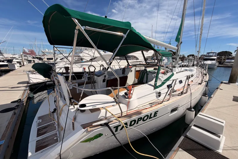Slide: The Image of Beneteau Oceanis Clipper 423 sailboat, 2005 model, docked at marina with green canopy. - 5