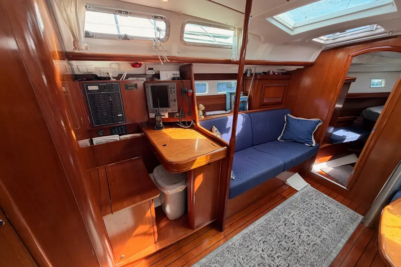 Slide: The Image of Interior of 2005 Beneteau Oceanis Clipper 423 yacht with wooden finish and blue seating. - 53