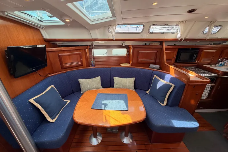 Slide: The Image of Luxurious interior of 2005 Beneteau Oceanis Clipper 423 yacht with cozy seating and elegant wood finish. - 56