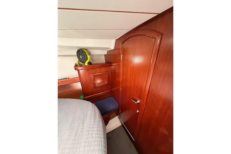 Slide: The Image of Interior cabin of 2005 Beneteau Oceanis Clipper 423 with wooden finish and storage. - 61