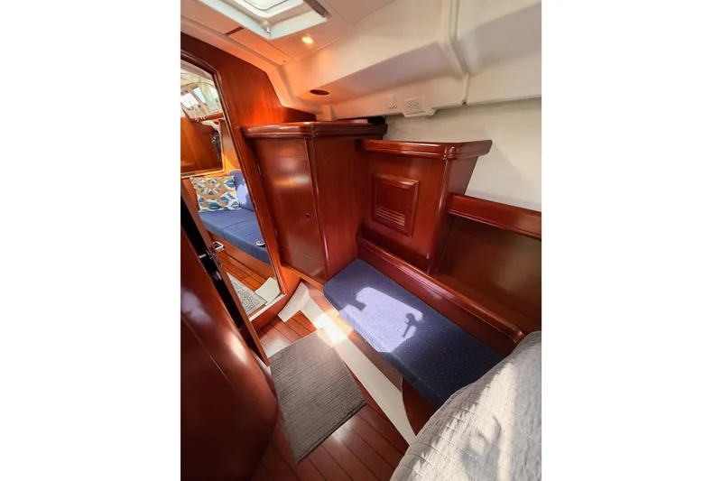 Slide: The Image of Interior of 2005 Beneteau Oceanis Clipper 423 with polished wood and cozy seating. - 67