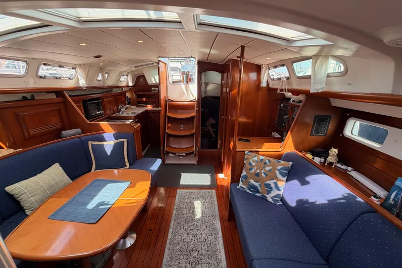 Slide: The Image of Interior of 2005 Beneteau Oceanis Clipper 423 yacht, featuring cozy seating and elegant wood finishes. - 68