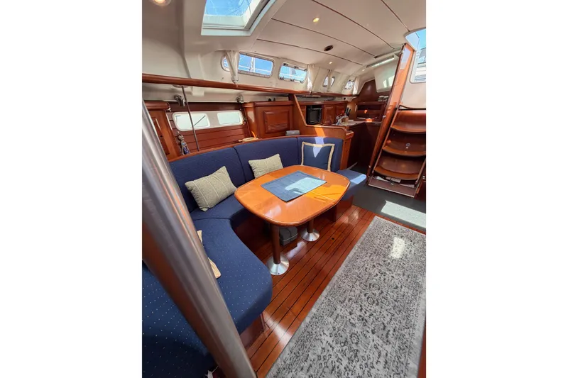 Slide: The Image of Interior of 2005 Beneteau Oceanis Clipper 423 yacht with cozy seating and wooden finishes. - 69