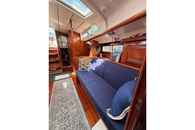 Slide: The Image of Interior of 2005 Beneteau Oceanis Clipper 423 yacht with blue sofa and wooden finish. - 70