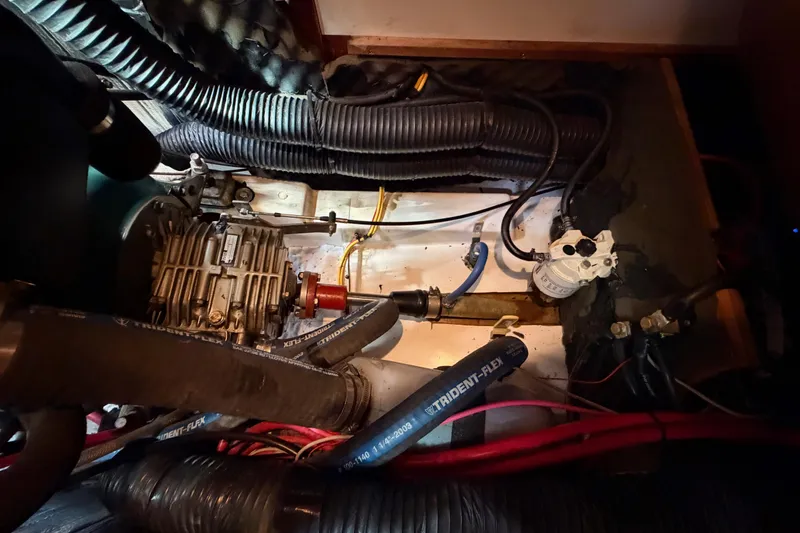 Slide: The Image of Engine compartment of a 2005 Beneteau Oceanis Clipper 423 sailboat, showing mechanical components and hoses. - 73