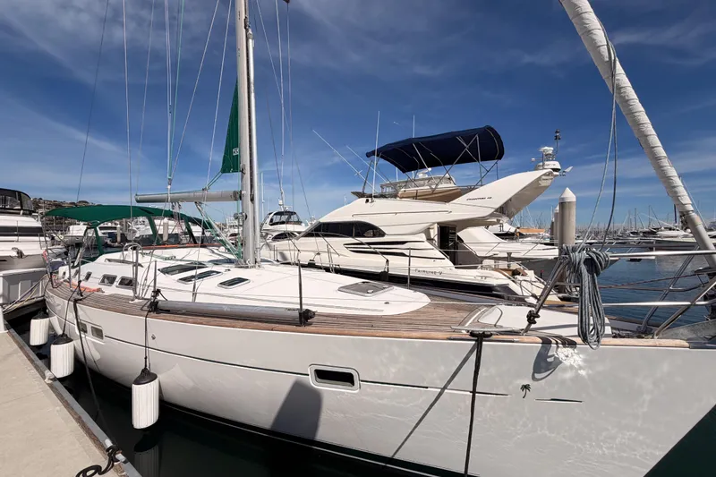 Slide: The Image of 2005 Beneteau Oceanis Clipper 423 sailboat docked at marina under clear blue sky. - 8