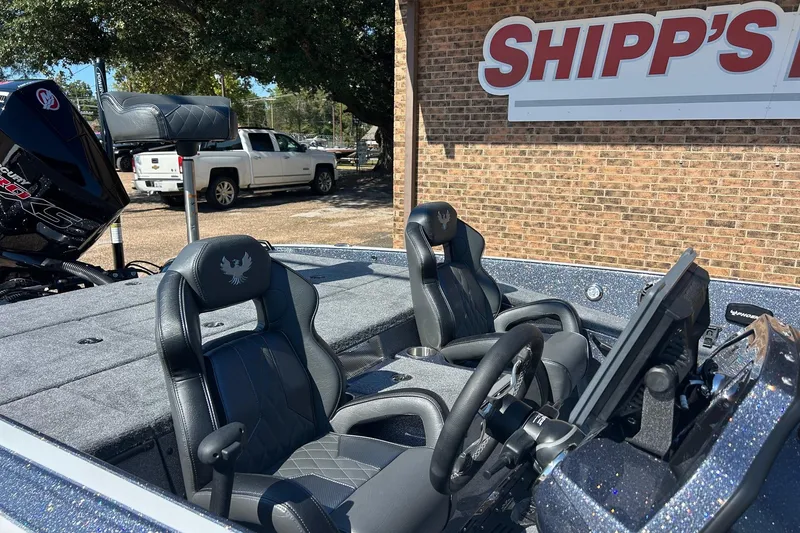 Slide: The Image of 2026 Phoenix 21 XE boat interior with dual seats and steering wheel, parked at Shipp's. - 10