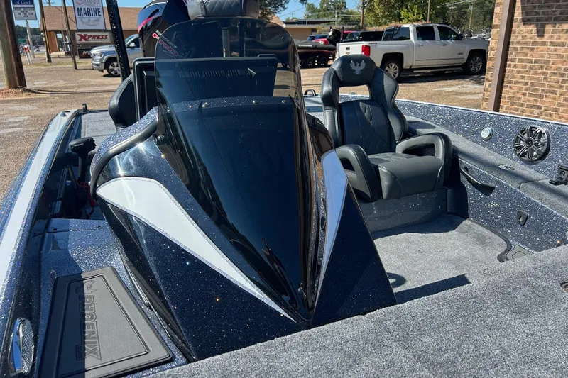 Slide: The Image of 2026 Phoenix 21 XE boat interior with sleek black seats and modern dashboard design. - 11
