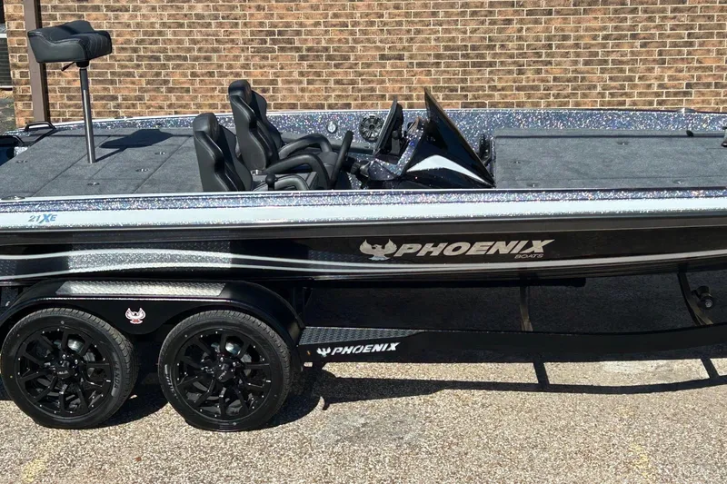 Slide: The Image of 2026 Phoenix 21 XE boat with sleek design and dual black wheels. - 4