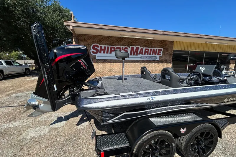 Slide: The Image of 2026 Phoenix 21 XE boat at Ship's Marine dealership, featuring sleek design and powerful engine. - 5