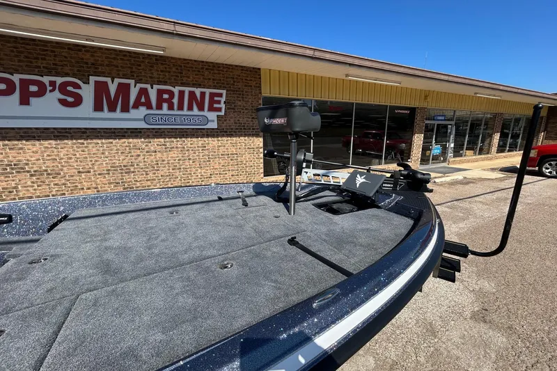 Slide: The Image of 2026 Phoenix 21 XE boat at dealership, showcasing spacious deck and modern design. - 7