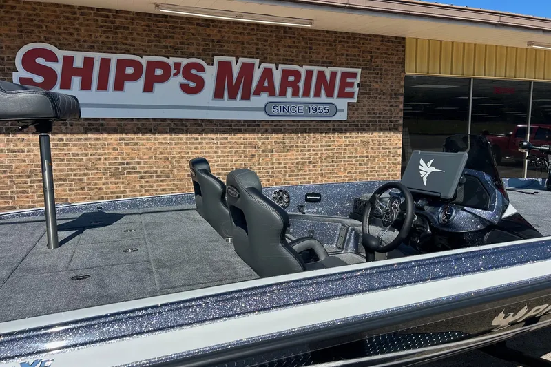 Slide: The Image of 2026 Phoenix 21 XE boat at Shipp's Marine dealership, showcasing sleek interior design. - 9